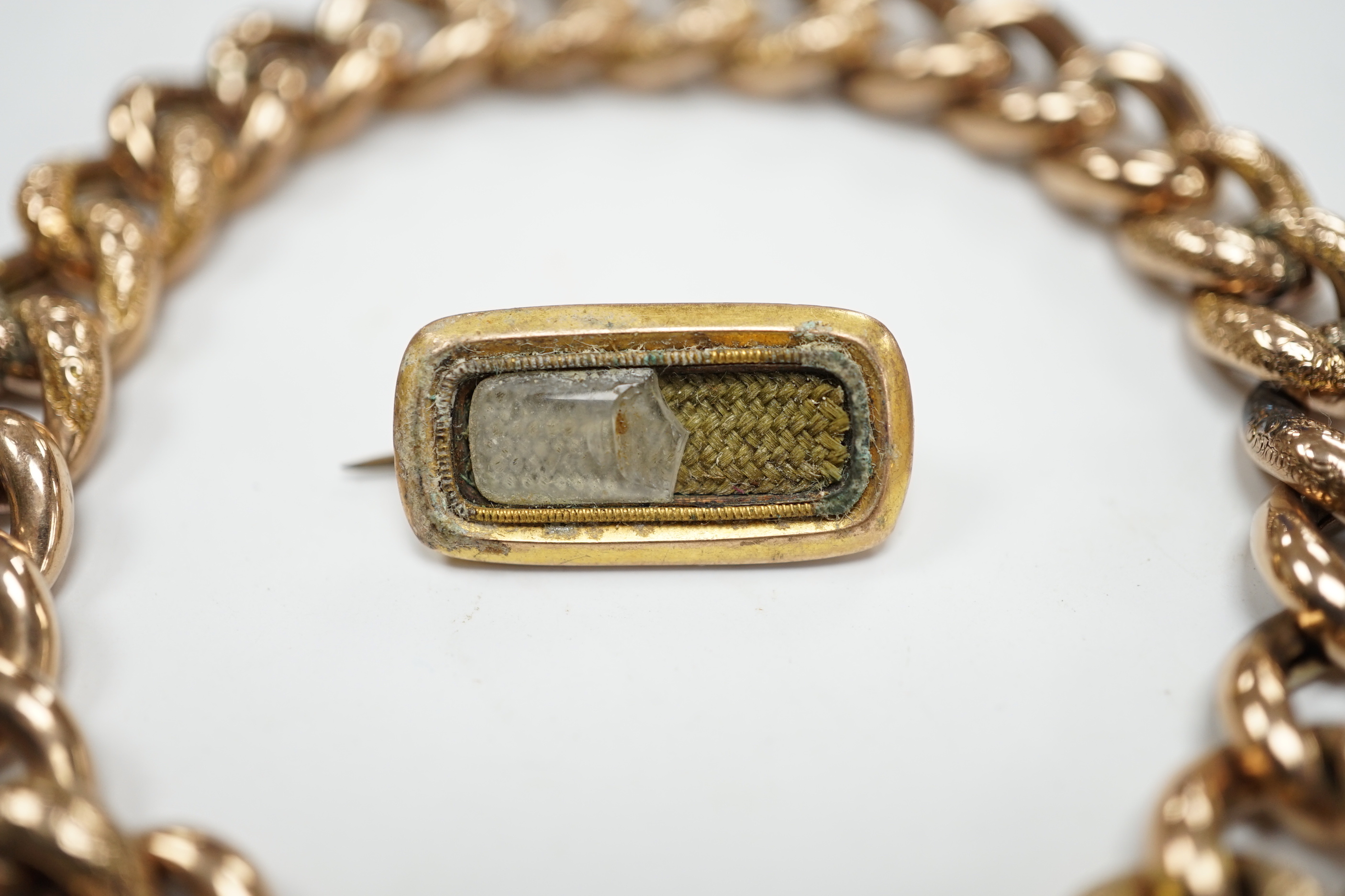 A 9ct curblink bracelet, with padlock clasp, 19cm, 22.6 grams and a 19th century brooch(a.f.)